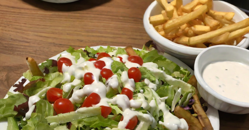 Image of a decadent salad and French fries, some of the best foods to eat with ranch.